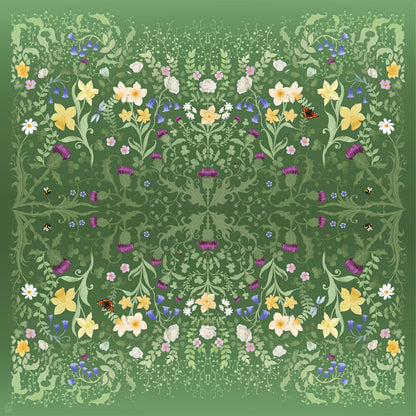 Silk scarf with a decorative pattern of flowers,  leaves, butterfiies and bumble bees  on a green background