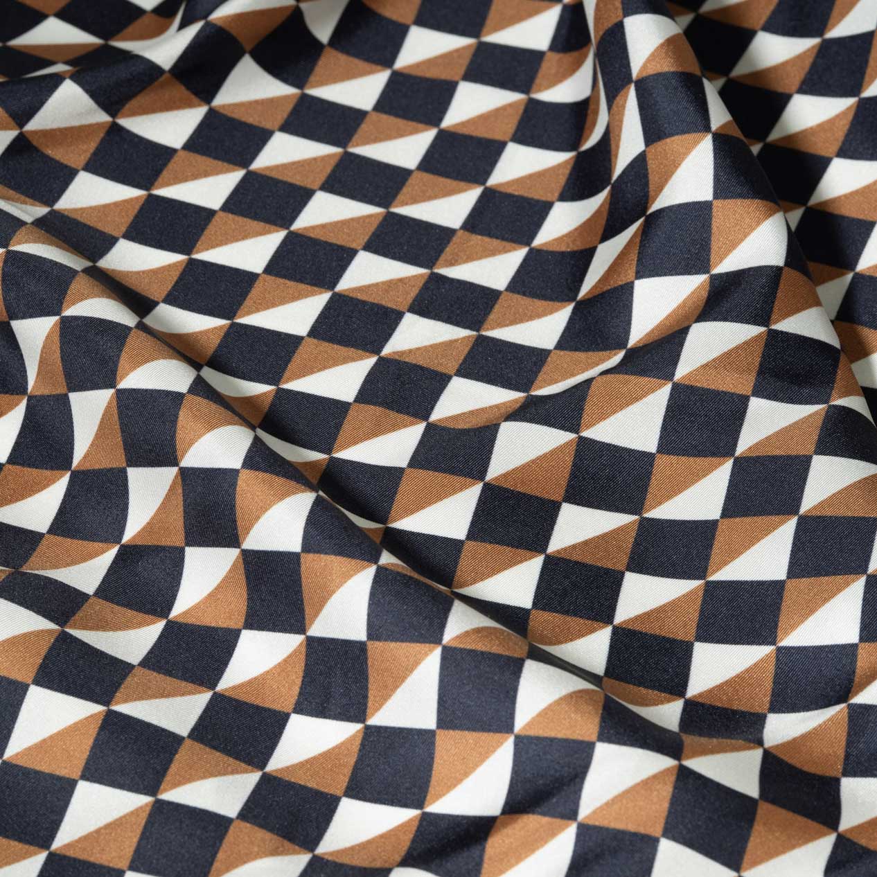 Fabric with a geometric style pattern in black, gold, and white.