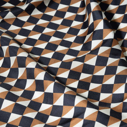 Fabric with a geometric style pattern in black, gold, and white.