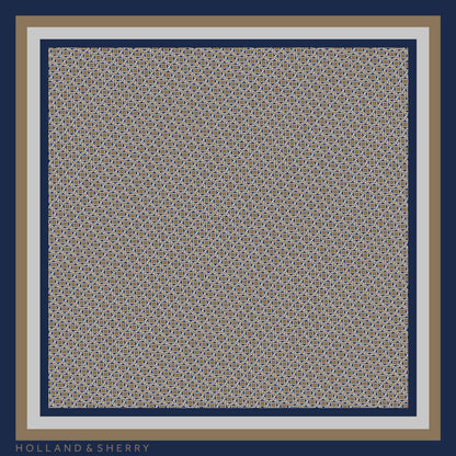 Patterned scarf with a repeating lion pattern and Holland & Sherry branding
