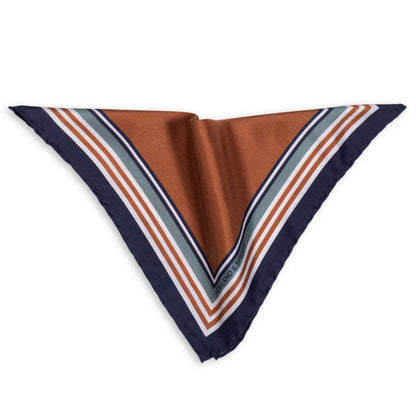 Pocket square with striped border in blue, gold, white and grey photographed on a white background.